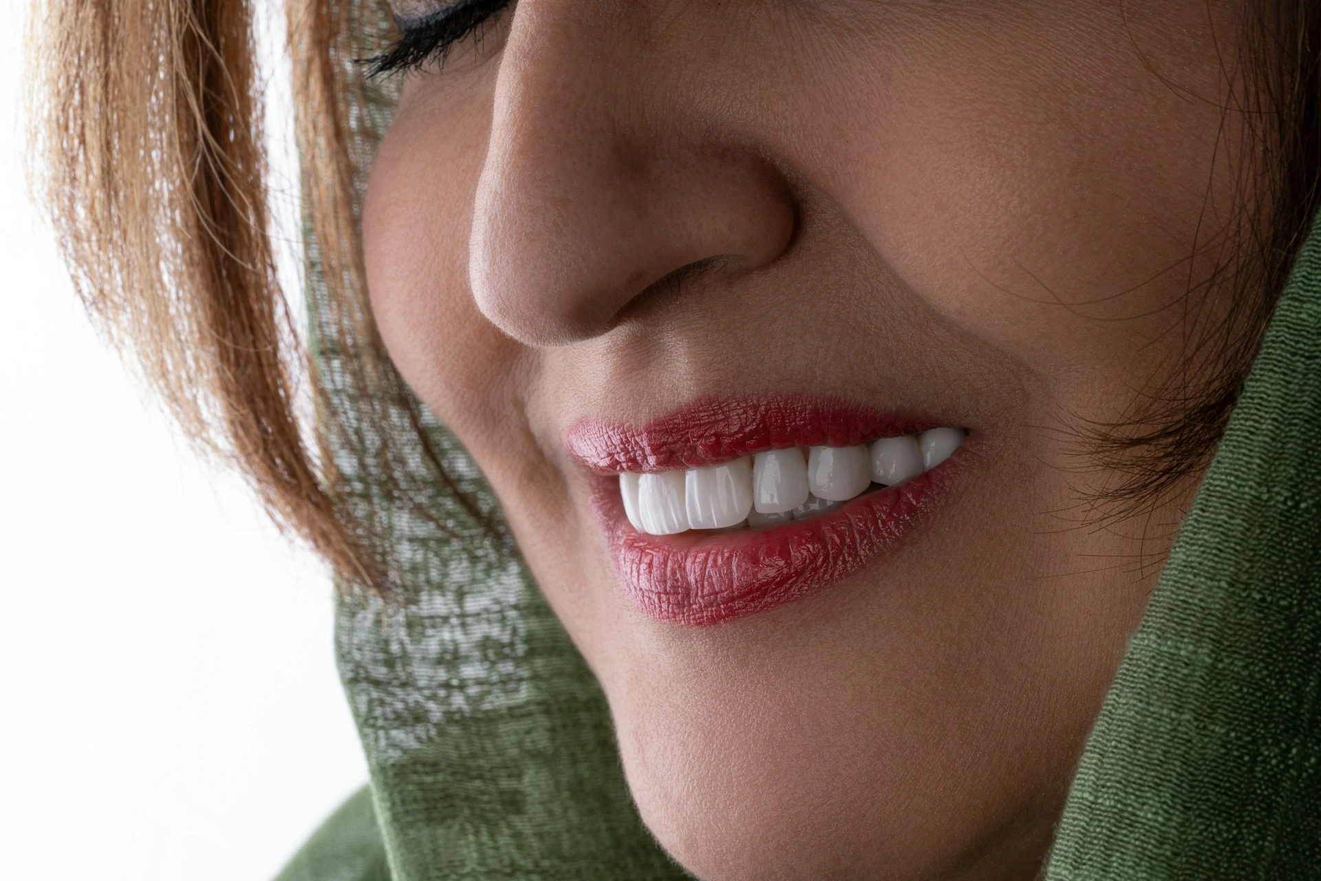 A close-up of women smiling with red lipstick on