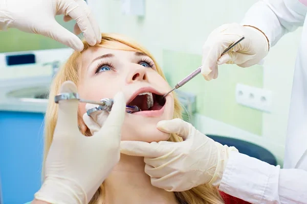A dental patient receiving a local anesthetic injection before an oral surgery or wisdom tooth extraction procedure