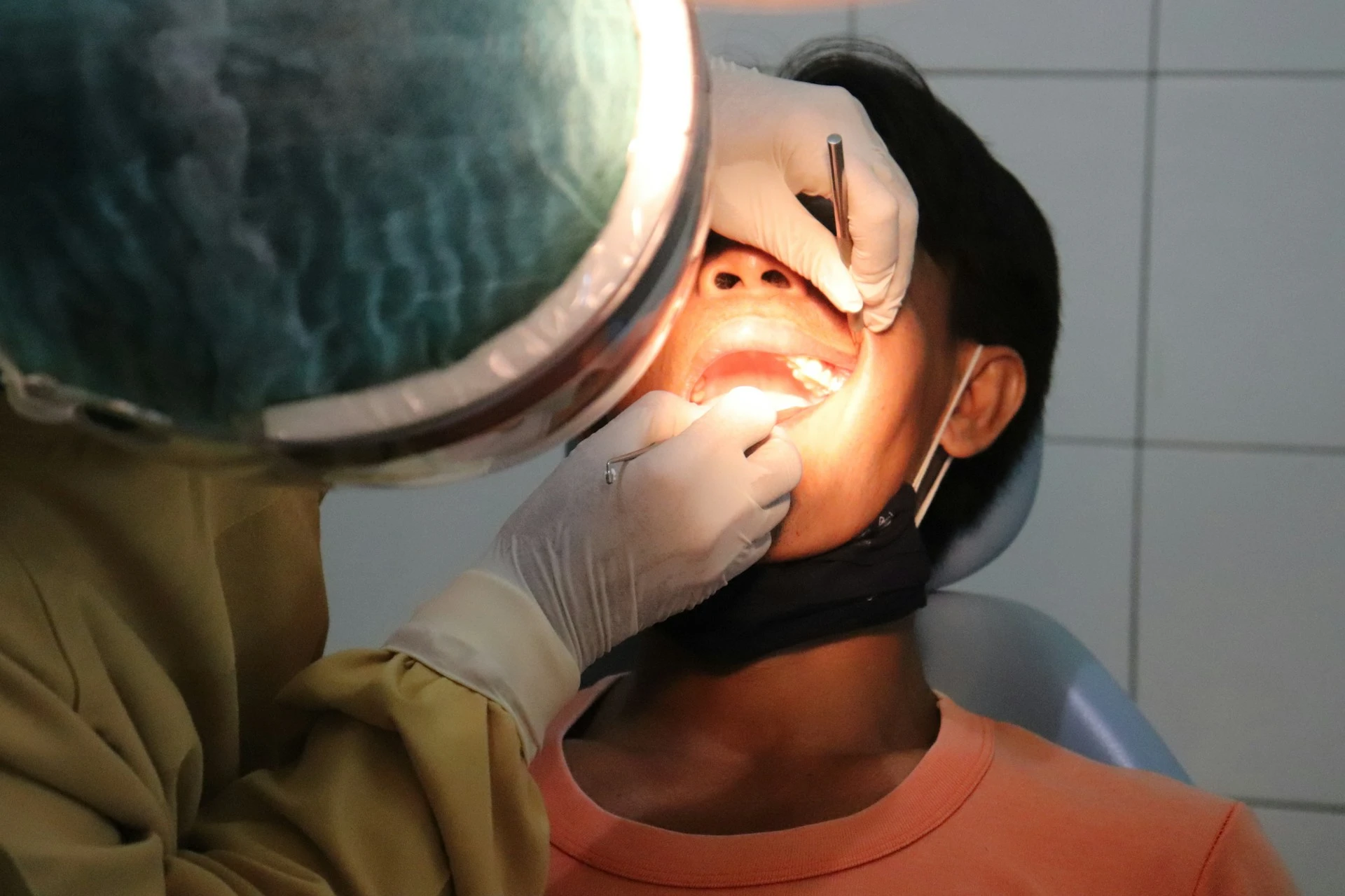 A dentist is filling cavities in a dental clinic