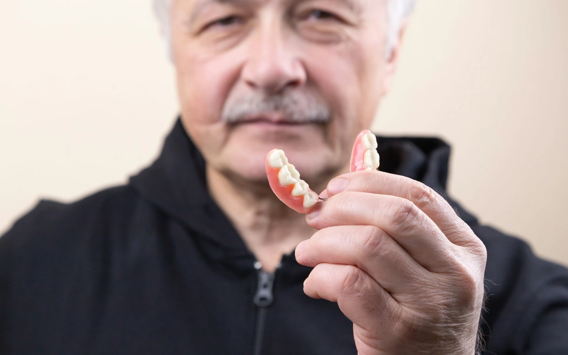 A man showing his removeable denture