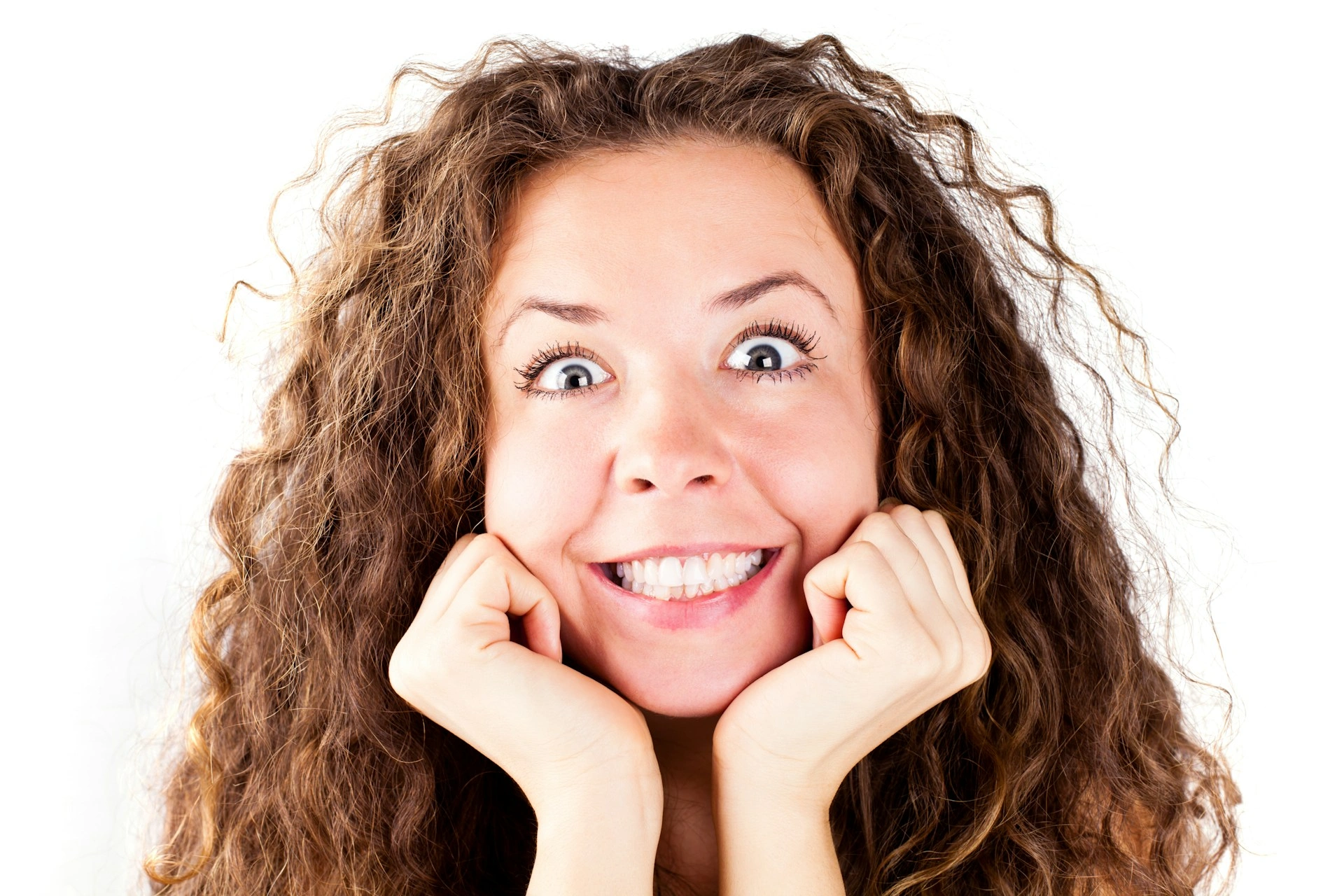 A woman with curly hair and a smile on her face