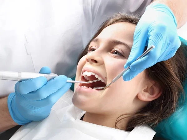 Child on a dental chair treated by a dentist