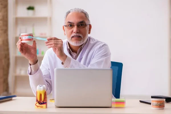 Dentist showing brushing technique