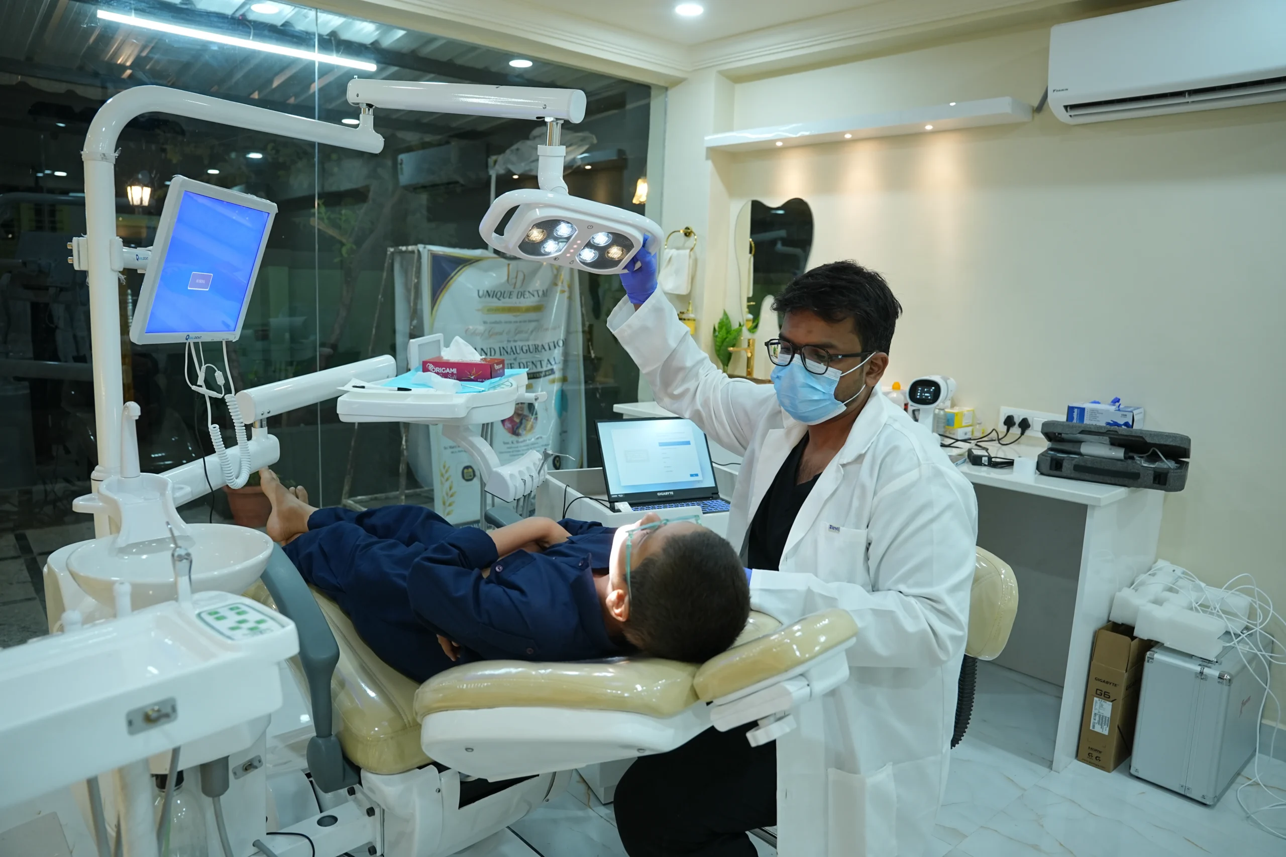 Dr. Rahmath performing a dental check-up at Unique Dental Clinic in Moula Ali.