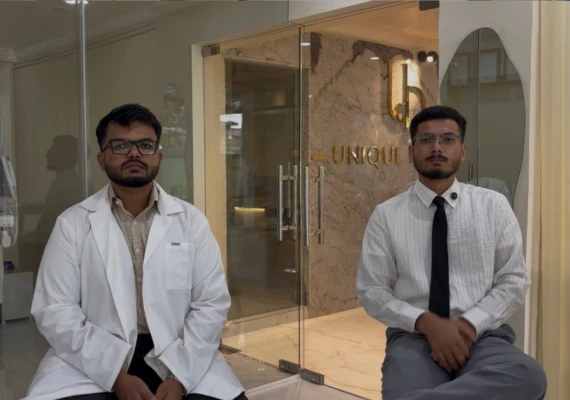 Dr. Rahmathullah Mohammed and Dr. Ahmed seated together inside the modern lobby of Unique Dental clinic in Moula Ali, Hyderabad, presenting a welcoming team of dental professionals.